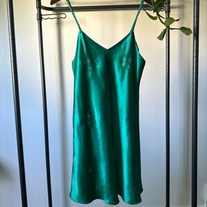 Vintage green slip dress with embroidered daises and braided straps.